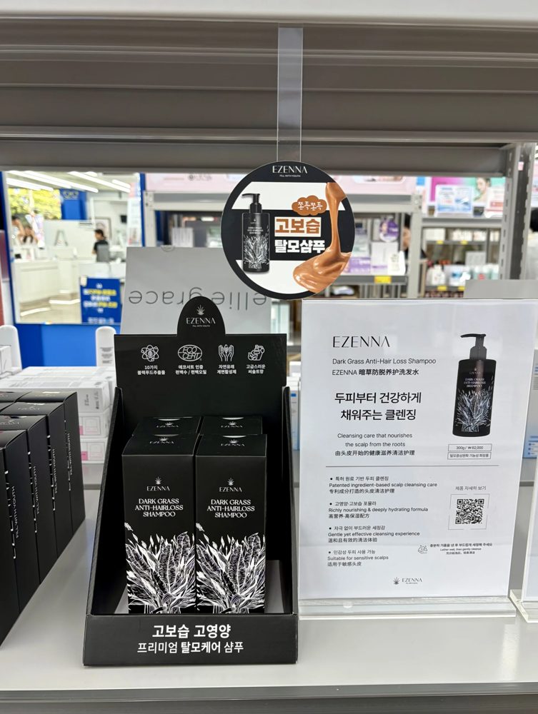 매장 선반의 이젠나 다크그라스 탈모샴푸 진열대와 두피 케어 클렌징 안내판